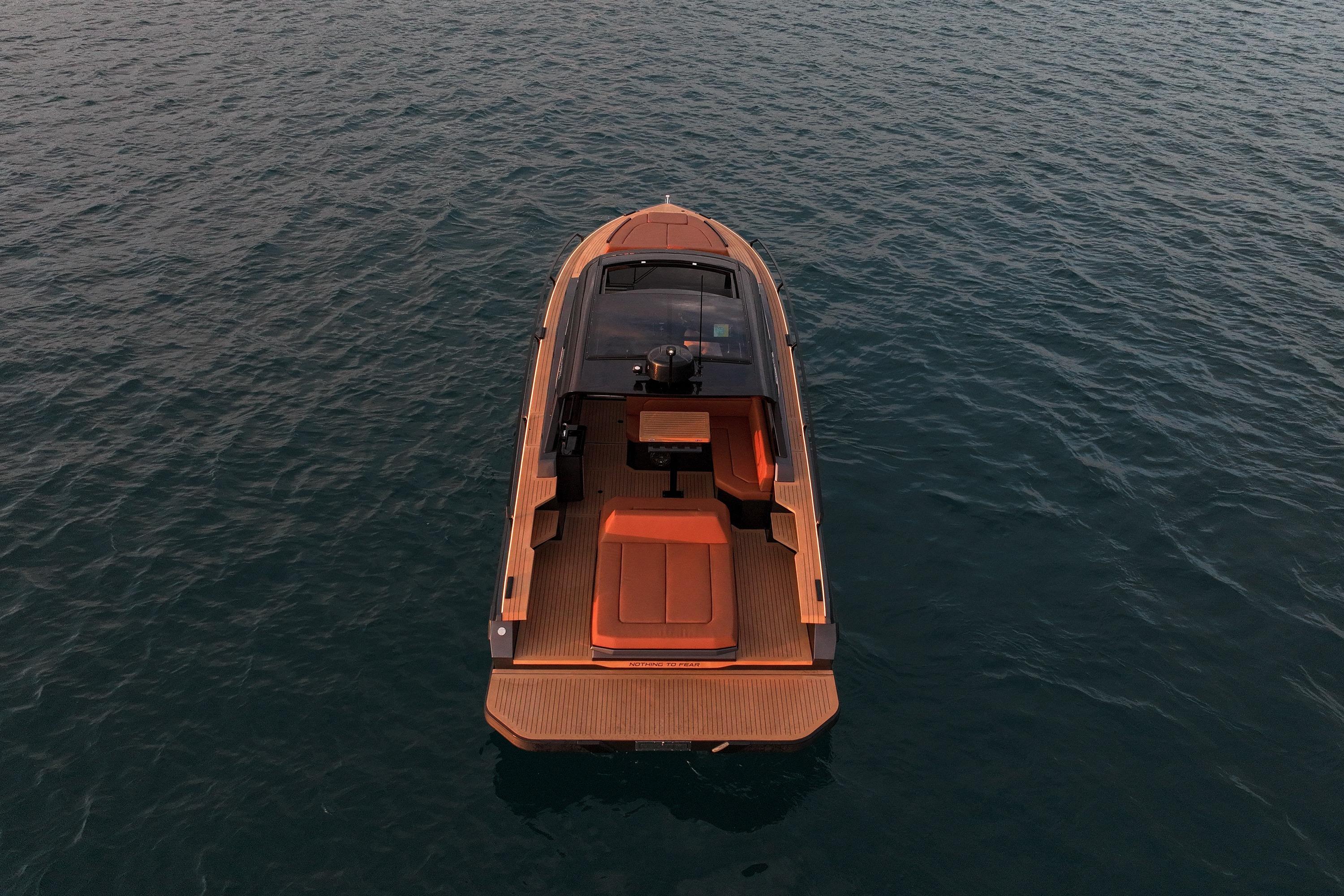 Luxury Focus 3X 2025 boat on calm water, aerial view.