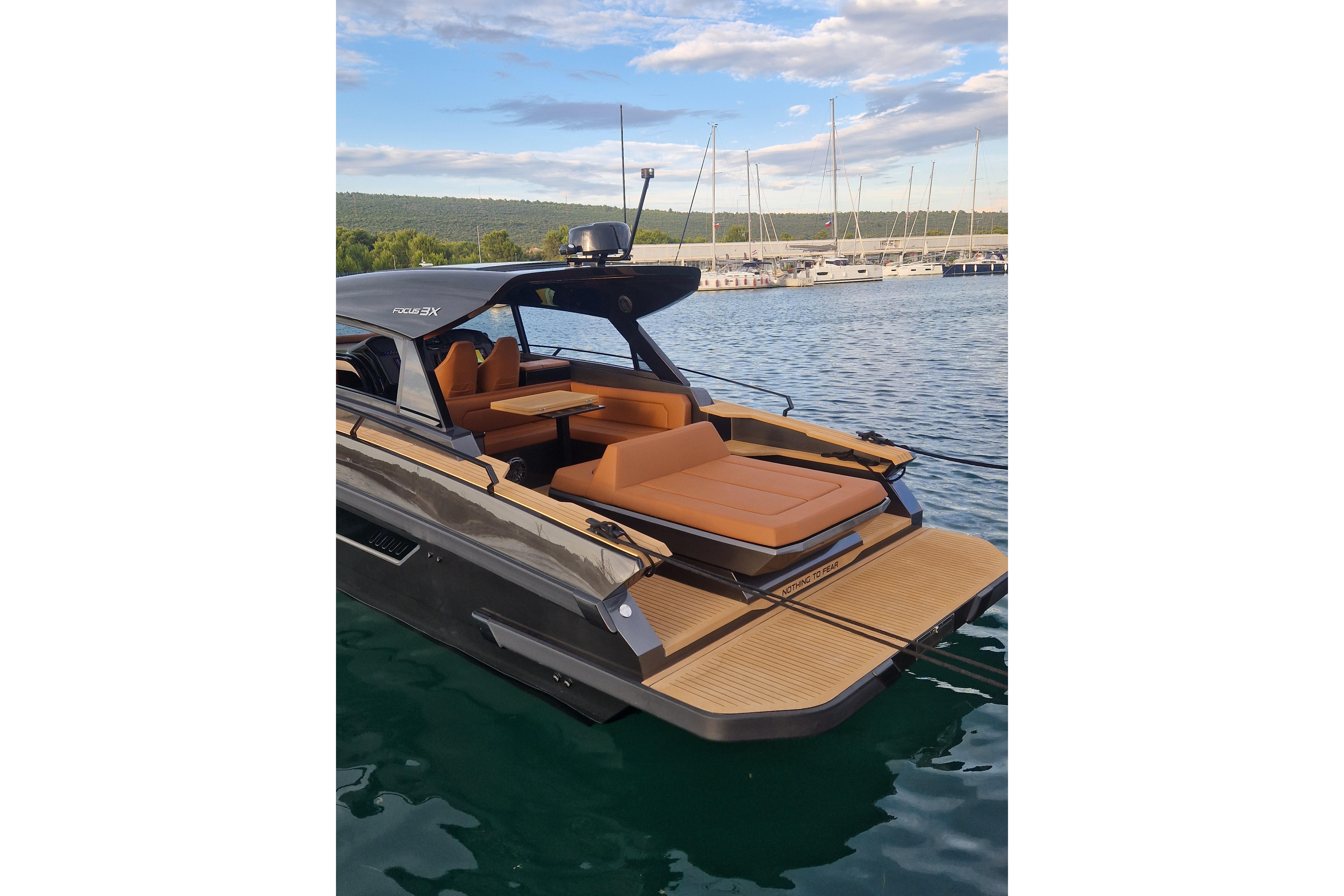 Luxurious 2025 Focus 3X yacht with sleek design and comfortable seating at marina.
