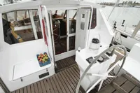 Cockpit of a 1991 Custom One Off boat with wooden deck and fruit basket.