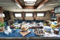 Luxurious yacht interior dining setup with elegant tableware and fresh food, Custom 0ne Off, 1991.