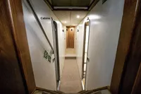 Narrow hallway with numbered cabin doors, Custom 0ne Off, 1991 model.