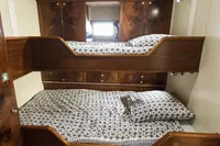 Bunk beds with patterned bedding in a custom 1991 one-off model interior.
