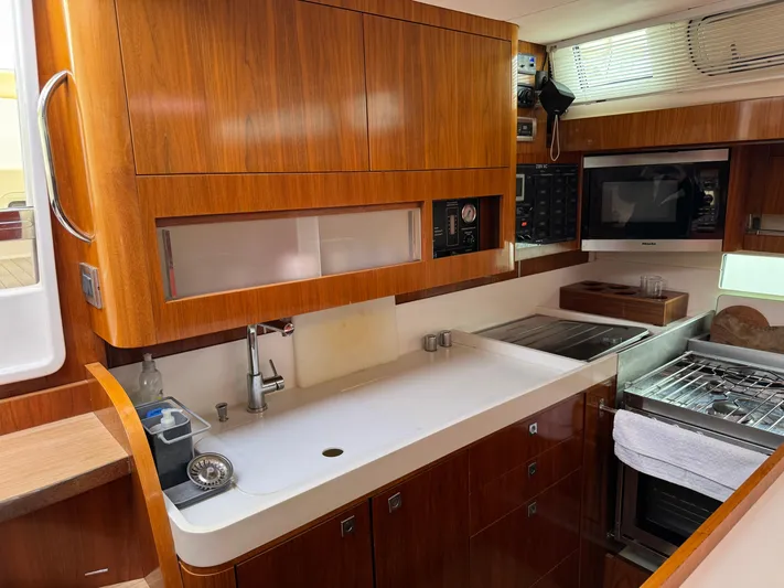 Marina Yacht Photos Pics Luxurious Amel 55 yacht kitchen interior with modern appliances and wooden cabinetry, 2012 model.