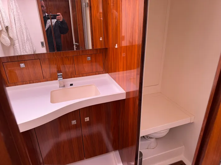 Marina Yacht Photos Pics Luxurious bathroom in 2012 Amel 55 yacht with wooden cabinetry and modern fixtures.