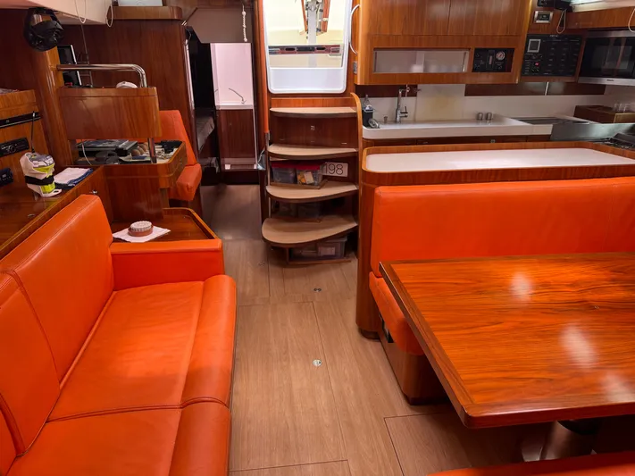 Marina Yacht Photos Pics Interior of 2012 Amel 55 yacht with orange seating and wooden finishes.