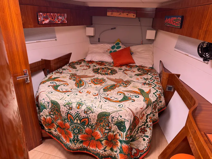 Marina Yacht Photos Pics Cozy cabin interior of 2012 Amel 55 yacht with vibrant floral bedspread.