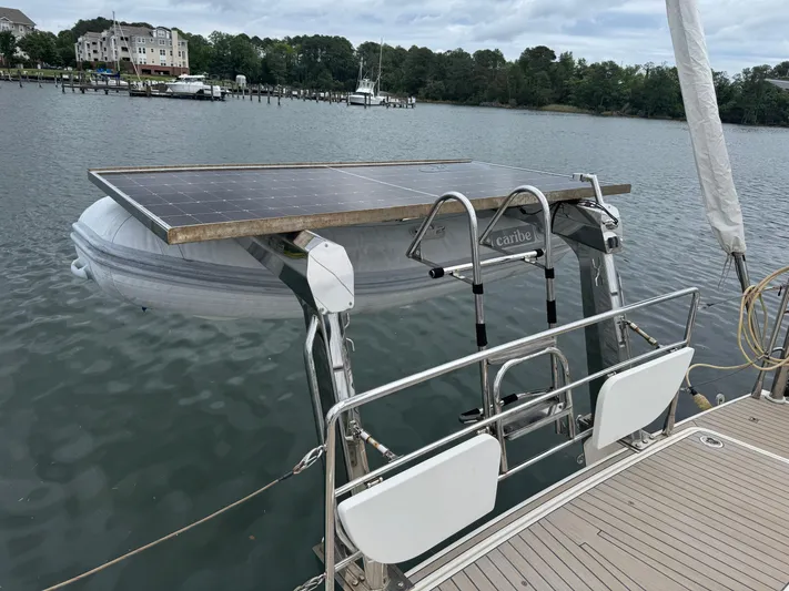 Marina Yacht Photos Pics Sailboat Amel 55 (2012) with solar panel and dinghy on a calm lake.