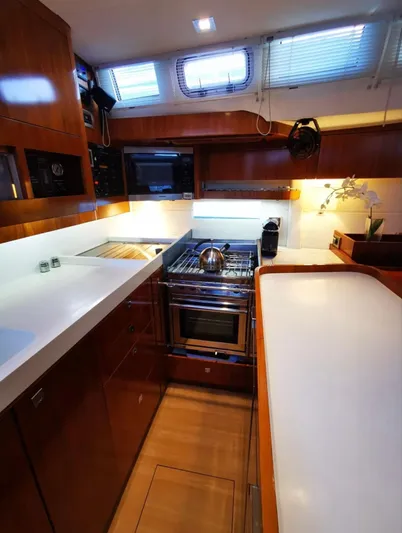 Marina Yacht Photos Pics Modern kitchen in 2012 Amel 55 yacht with sleek countertops and stainless steel appliances.