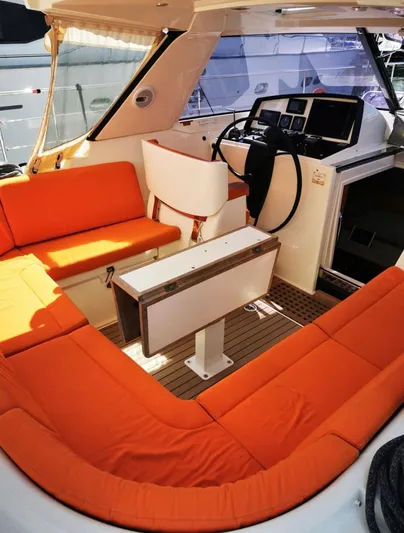 Marina Yacht Photos Pics Interior of 2012 Amel 55 yacht with orange seating and modern helm.