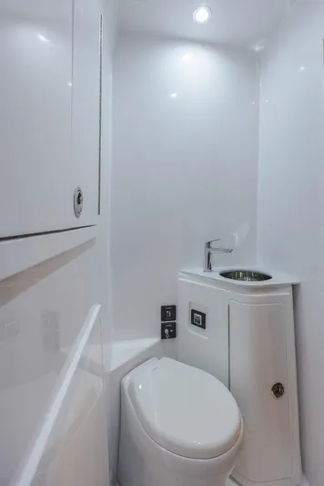  Yacht Photos Pics Modern bathroom in 2023 Front Runner 47 boat, featuring sleek white design and compact fixtures.