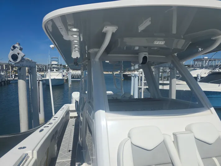  Yacht Photos Pics 2024 Invincible 43 Open Fisherman boat docked at marina, showcasing sleek design and spacious deck.