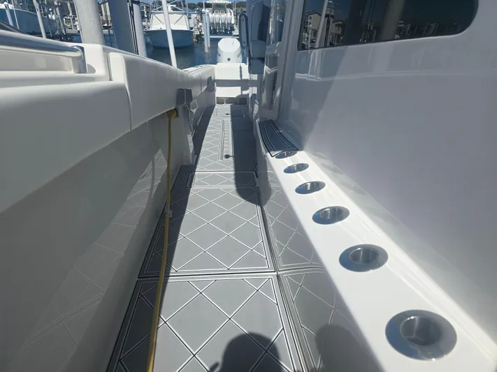  Yacht Photos Pics 2024 Invincible 43 Open Fisherman boat deck with rod holders and sleek design.