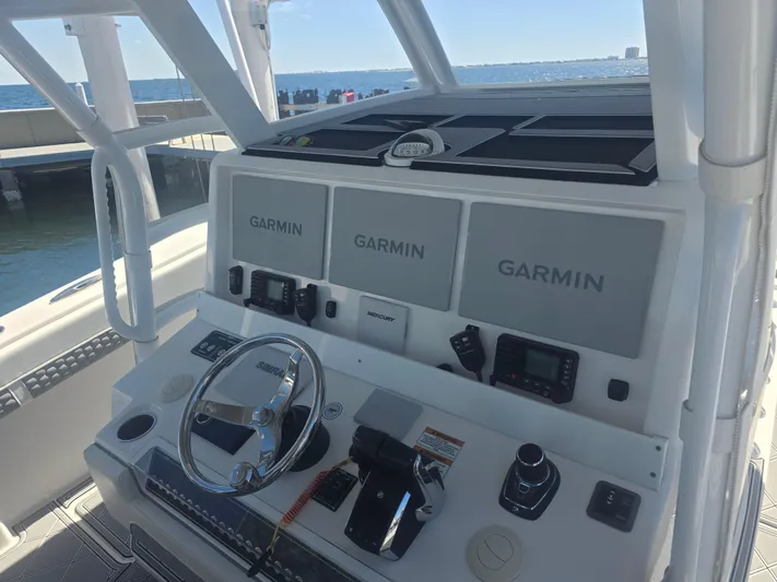  Yacht Photos Pics 2024 Invincible 43 Open Fisherman boat dashboard with Garmin navigation displays.
