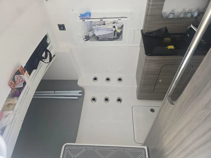  Yacht Photos Pics 2024 Invincible 43 Open Fisherman interior with storage and sink area.