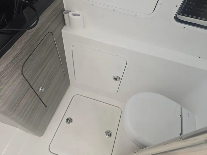  Yacht Photos Pics 2024 Invincible 43 Open Fisherman boat interior with toilet and storage compartments.