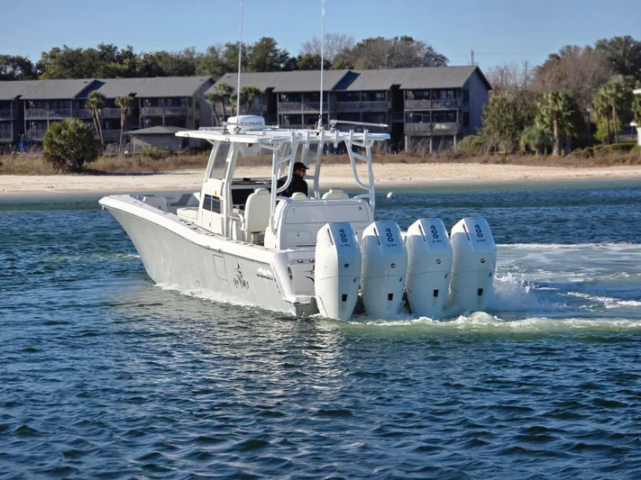  Yacht Photos Pics 2024 Invincible 43 Open Fisherman boat cruising on water with four engines.