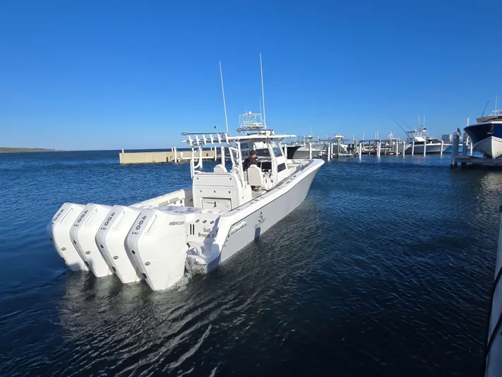  Yacht Photos Pics 2024 Invincible 43 Open Fisherman boat with multiple engines docked in marina.