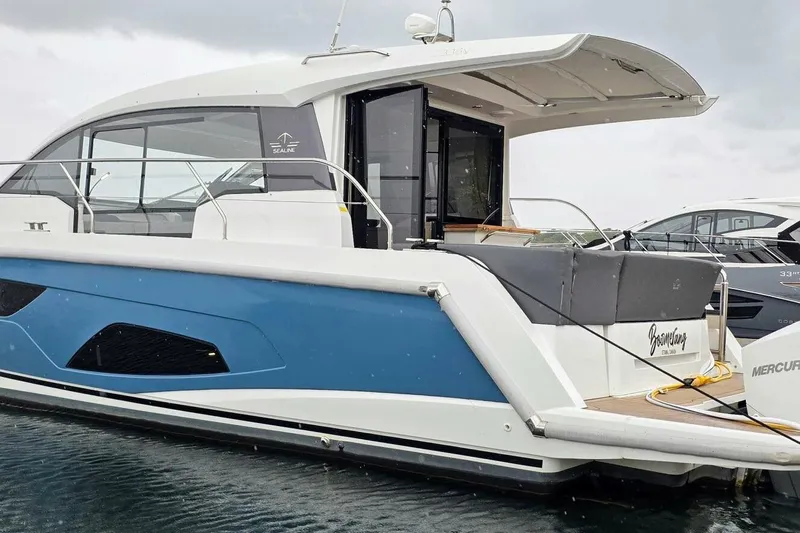 Yacht Photos Pics 2023 Sealine C335V yacht with sleek design, docked on calm water.