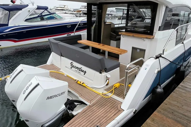  Yacht Photos Pics 2023 Sealine C335V yacht with dual Mercury outboard engines, docked at a marina.