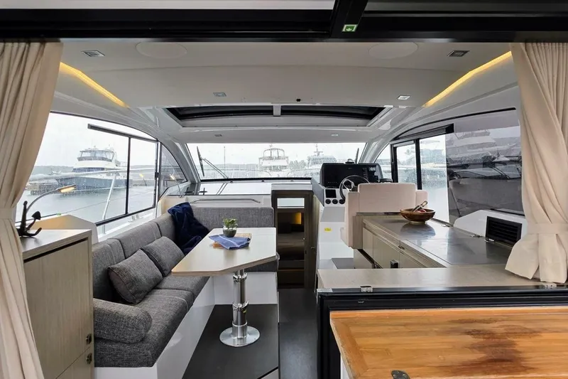  Yacht Photos Pics Interior of 2023 Sealine C335V yacht, featuring modern seating and dining area with panoramic windows.