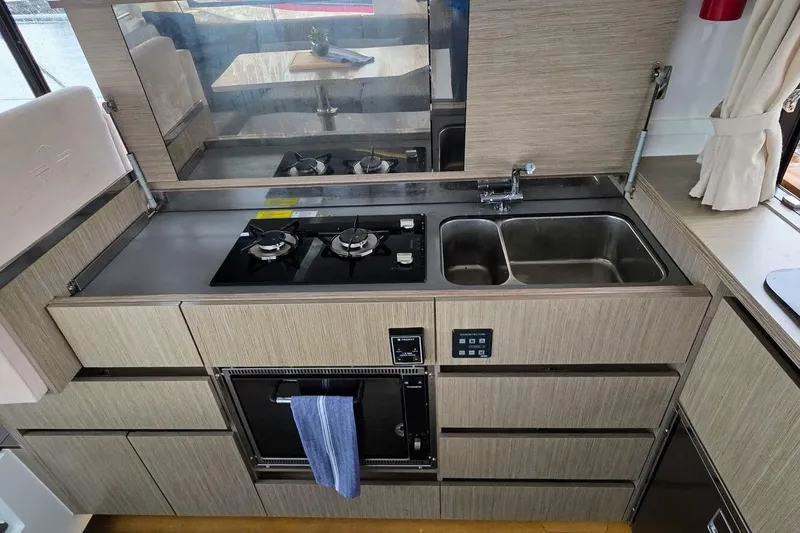  Yacht Photos Pics Modern kitchen in 2023 Sealine C335V yacht with stove, sink, and oven.