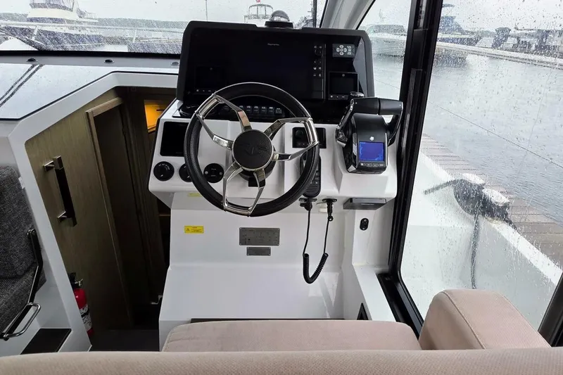  Yacht Photos Pics 2023 Sealine C335V boat cockpit with steering wheel and control panel.