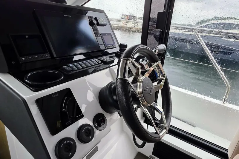  Yacht Photos Pics Steering console of 2023 Sealine C335V yacht with modern navigation equipment.