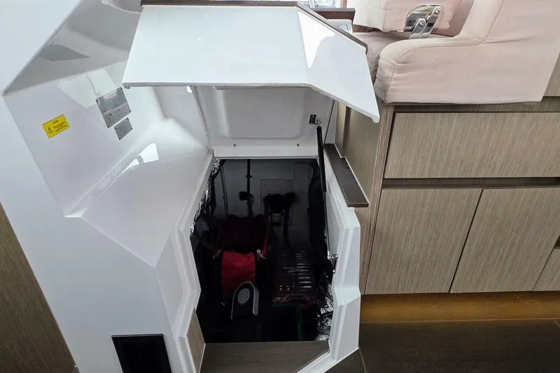  Yacht Photos Pics 2023 Sealine C335V yacht interior storage compartment with open hatch and modern design.
