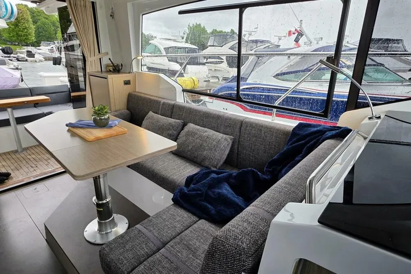  Yacht Photos Pics Interior of 2023 Sealine C335V yacht with cozy seating and dining area.