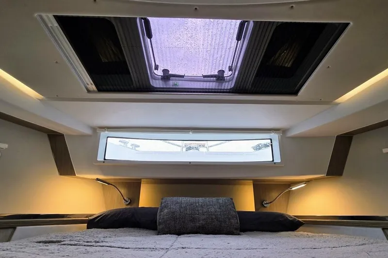  Yacht Photos Pics Luxurious interior cabin of 2023 Sealine C335V yacht with skylight and modern lighting.