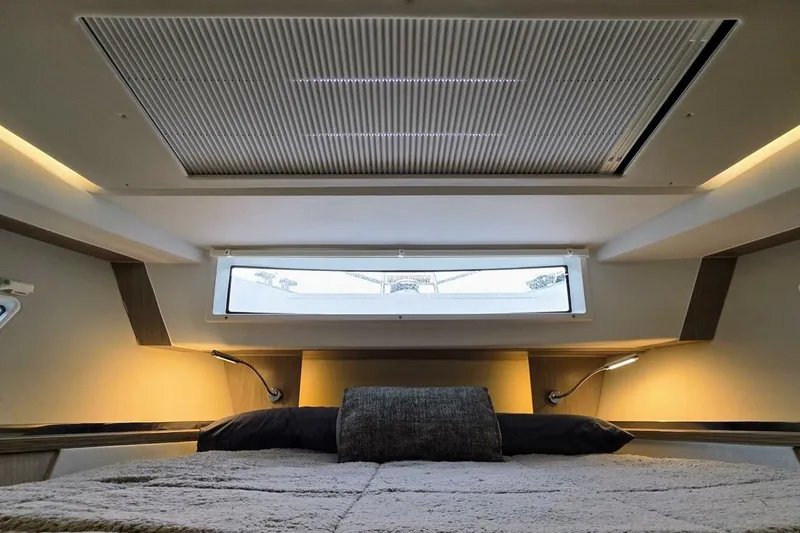  Yacht Photos Pics Luxurious interior cabin of 2023 Sealine C335V yacht with modern lighting and cozy bedding.