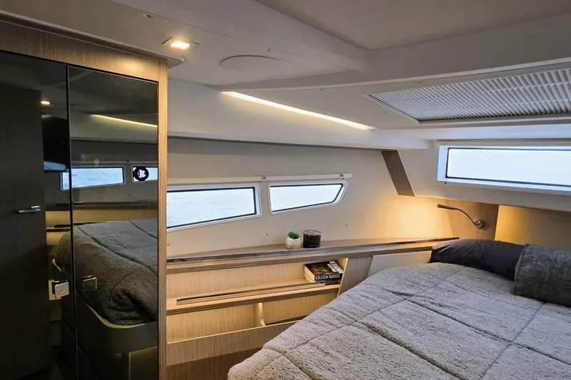  Yacht Photos Pics Luxurious interior of 2023 Sealine C335V yacht cabin with modern design and cozy bedding.