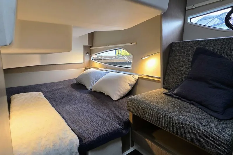  Yacht Photos Pics 2023 Sealine C335V cabin interior with cozy bed and seating area.