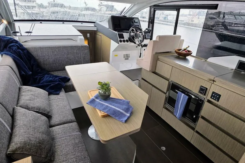  Yacht Photos Pics Interior of 2023 Sealine C335V yacht with modern kitchen and seating area.