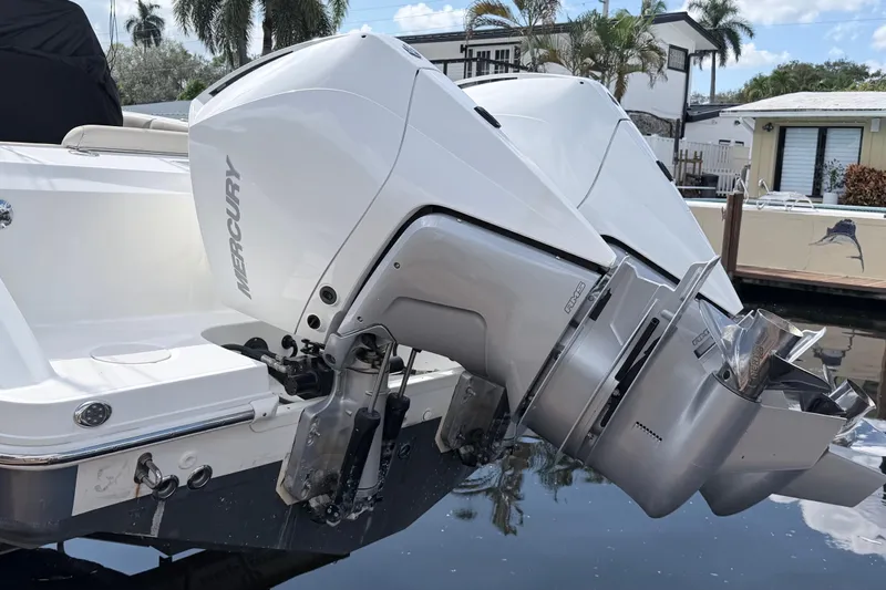  Yacht Photos Pics 2017 Boston Whaler 330 Outrage with dual Mercury outboard engines docked by waterfront homes.