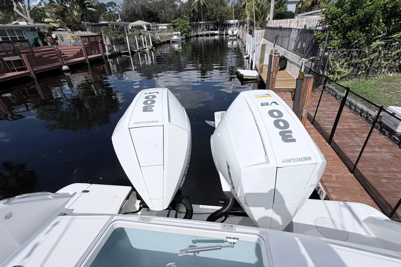  Yacht Photos Pics Boston Whaler 330 Outrage 2017 with twin Mercury 300 engines docked by a canal.