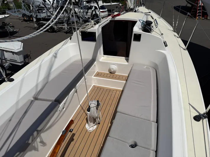 Evelyn Yacht Photos Pics 2022 J Boats J/9 sailboat cockpit with cushioned seating and teak flooring.