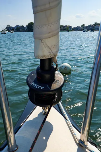 Evelyn Yacht Photos Pics Bow of 2022 J Boats J/9 sailboat on water, with visible rigging and shoreline in background.