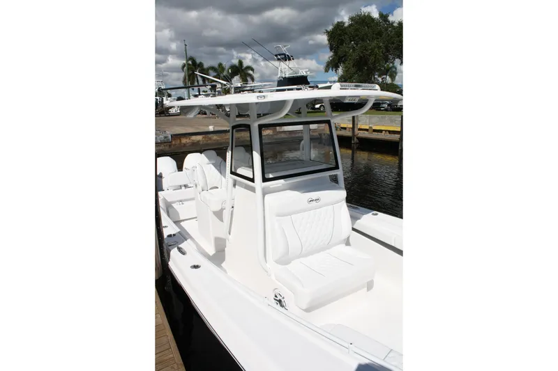  Yacht Photos Pics 2026 Limitless 270 boat with sleek white design docked by the water.