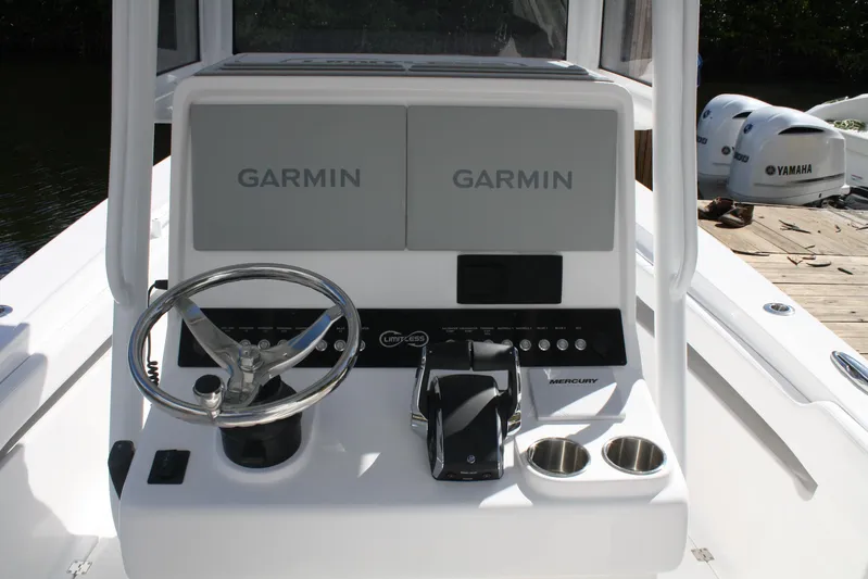  Yacht Photos Pics Steering console of Limitless 270 boat, featuring Garmin displays and Mercury controls, 2026 model.