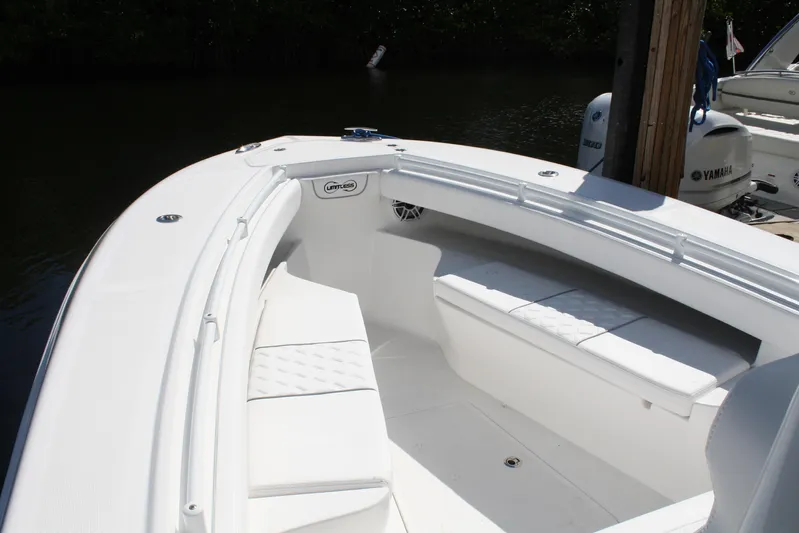  Yacht Photos Pics Front seating area of a 2026 Limitless 270 boat, docked with Yamaha engine visible.