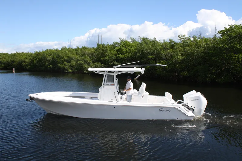  Yacht Photos Pics 2026 Limitless 270 boat cruising on a calm river with lush greenery.