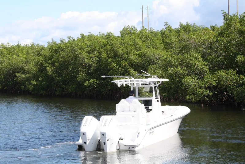 Yacht Photos Pics White Limitless 270 boat cruising through lush mangrove-lined waterway, 2026 model.