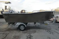 2024 Robust Boats Robust 16c on trailer, side view in a boatyard.