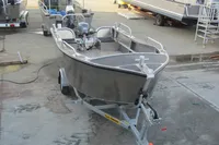 2024 Robust Boats Robust 16c on trailer, displayed in a boatyard setting.