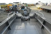 2024 Robust Boats Robust 16c, aluminum interior, docked with other boats in a marina.