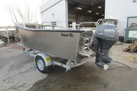 2024 Robust Boats Robust 16c with Yamaha outboard motor on trailer, parked outside a workshop.