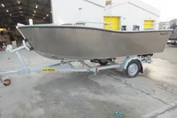 2024 Robust Boats Robust 16c on trailer outside a warehouse.