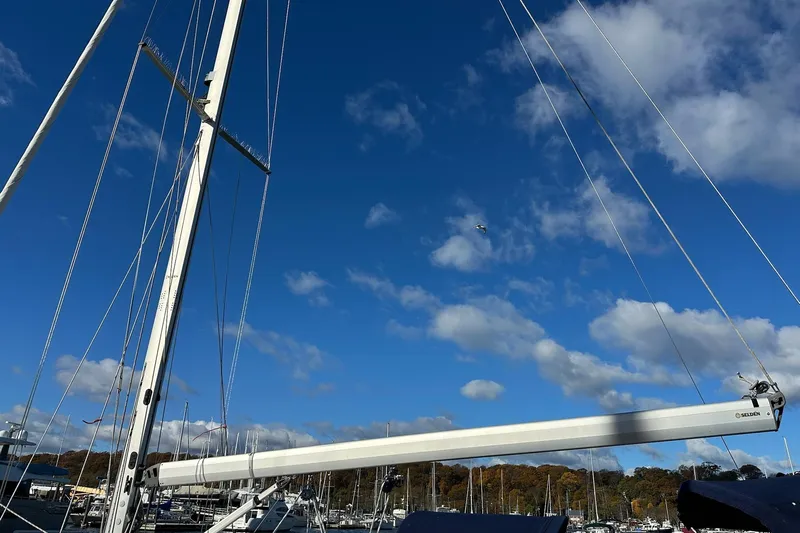  Yacht Photos Pics Sailboat mast of 2015 Catalina 315 against a clear blue sky with clouds.