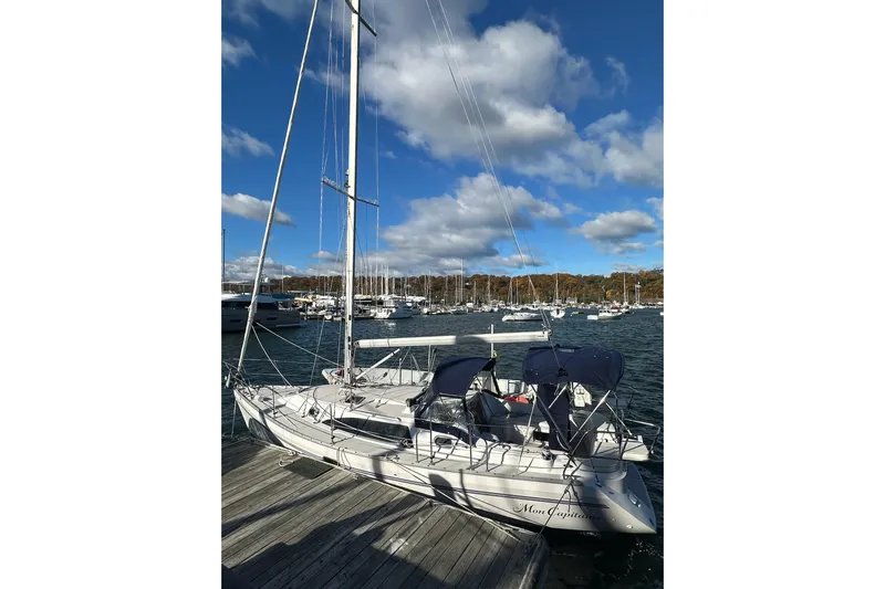  Yacht Photos Pics 2015 Catalina 315 sailboat docked at a marina under a blue sky with clouds.